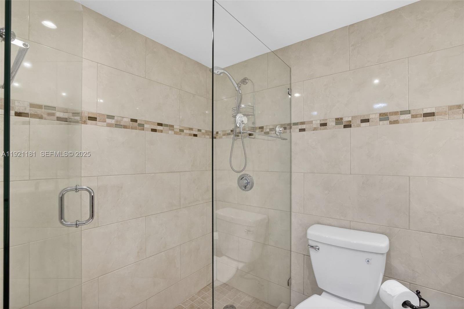 200 Diplomat Parkway, Unit 531 Hallandale Beach, FL 33009 - Photo 28 of 45 a bathroom with a toilet and shower