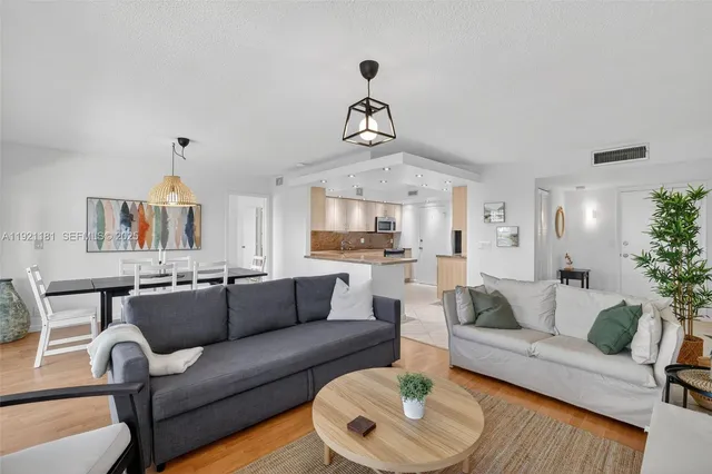 a living room with furniture and a chandelier