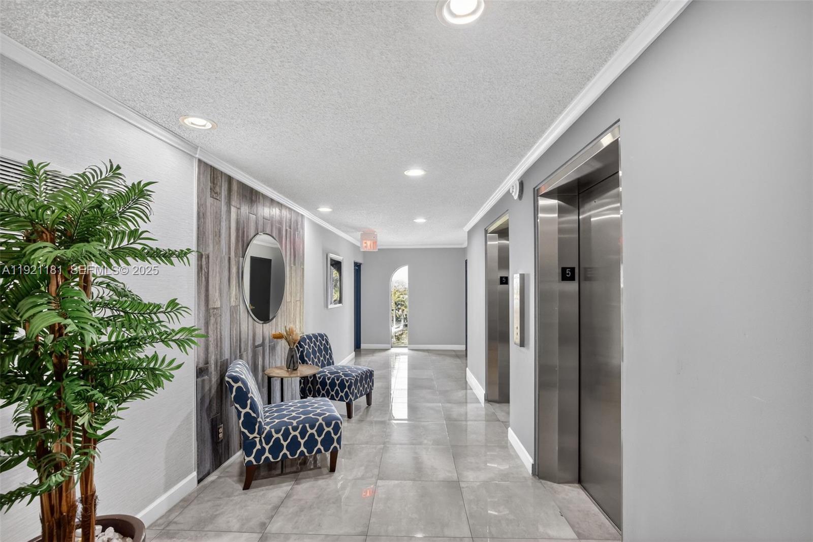 200 Diplomat Parkway, Unit 531 Hallandale Beach, FL 33009 - Photo 32 of 45 a lobby with furniture and potted plants