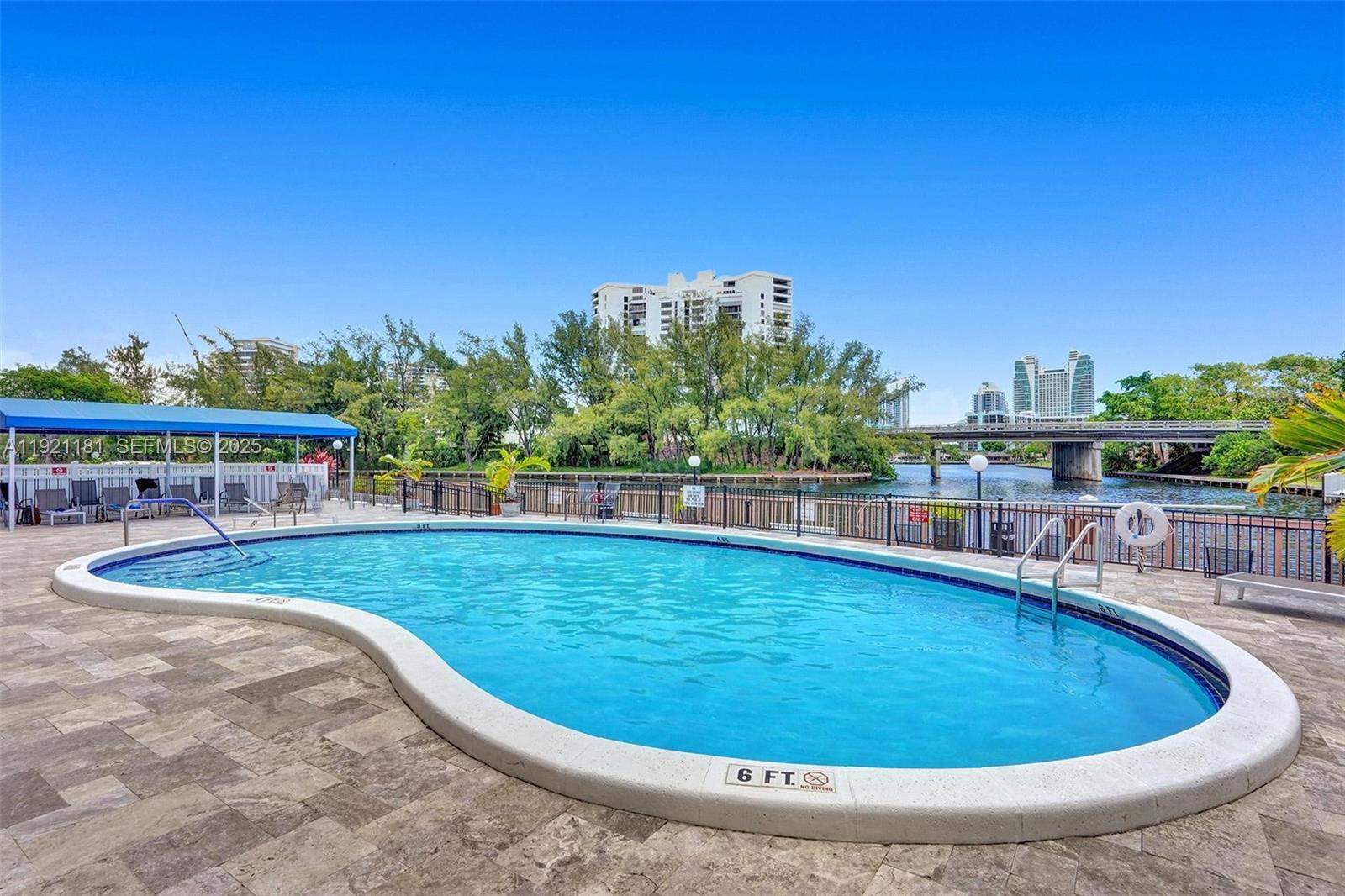 200 Diplomat Parkway, Unit 531 Hallandale Beach, FL 33009 - Photo 40 of 45 a view of a swimming pool with lawn chairs