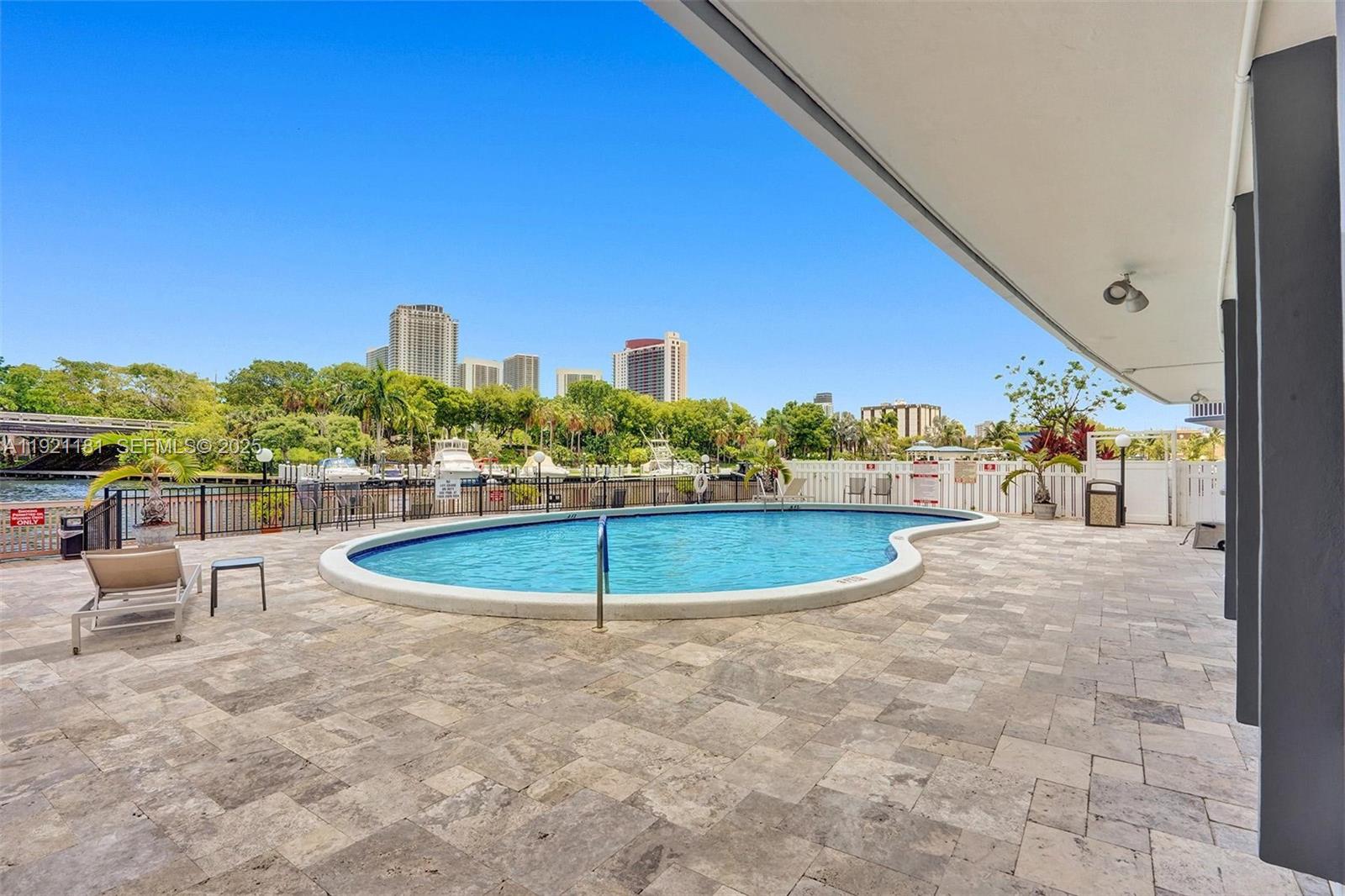 200 Diplomat Parkway, Unit 531 Hallandale Beach, FL 33009 - Photo 41 of 45 a view of a swimming pool with chairs