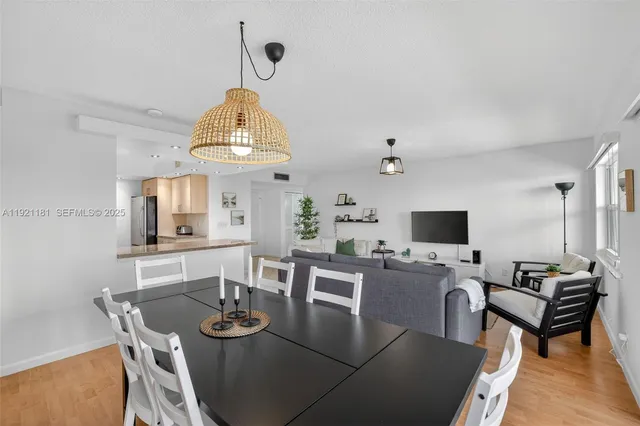 a living room with stainless steel appliances granite countertop furniture and a view of living room