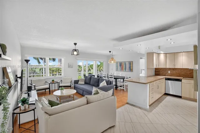 a kitchen with stainless steel appliances granite countertop a sink and a refrigerator