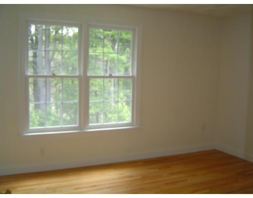 8 Stonebridge Road Groveland, MA 01834 - Photo 14 of 20 a view of an empty room with wooden floor and windows