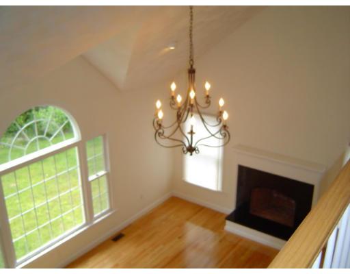 8 Stonebridge Road Groveland, MA 01834 - Photo 10 of 20 a living room with a fireplace furniture and a large window