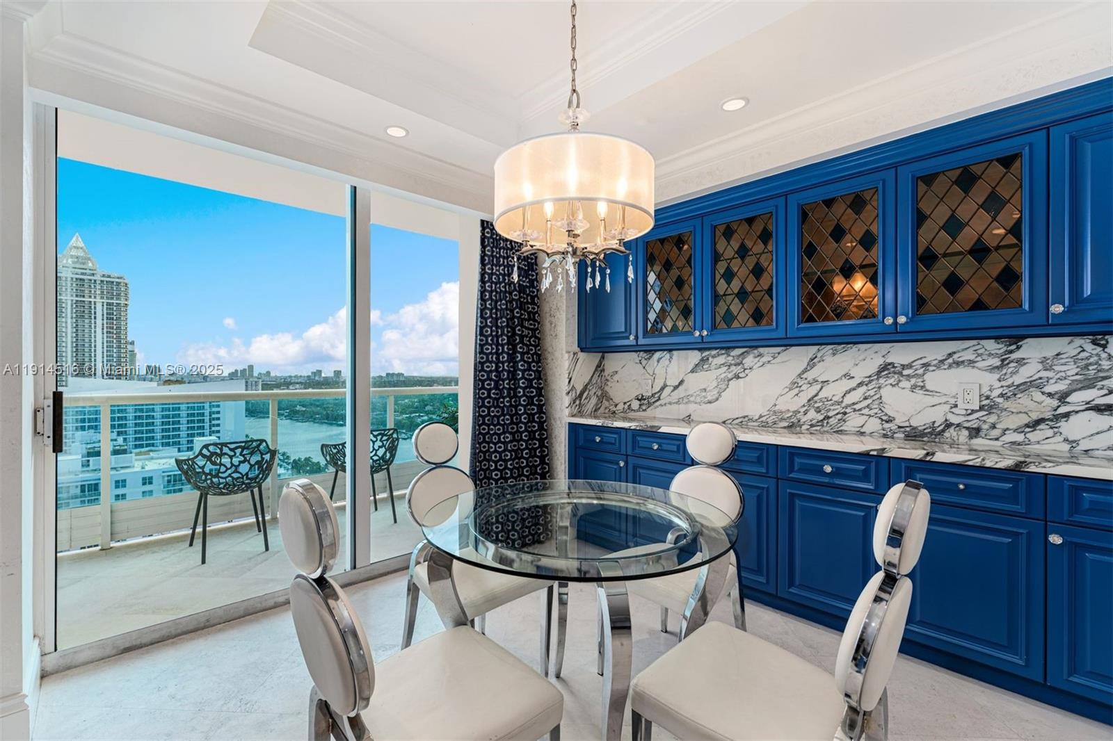 5025 Collins Avenue, Unit PH1 Miami Beach, FL 33140 - Photo 13 of 62 a view of a dining room with furniture wooden floor and a chandelier