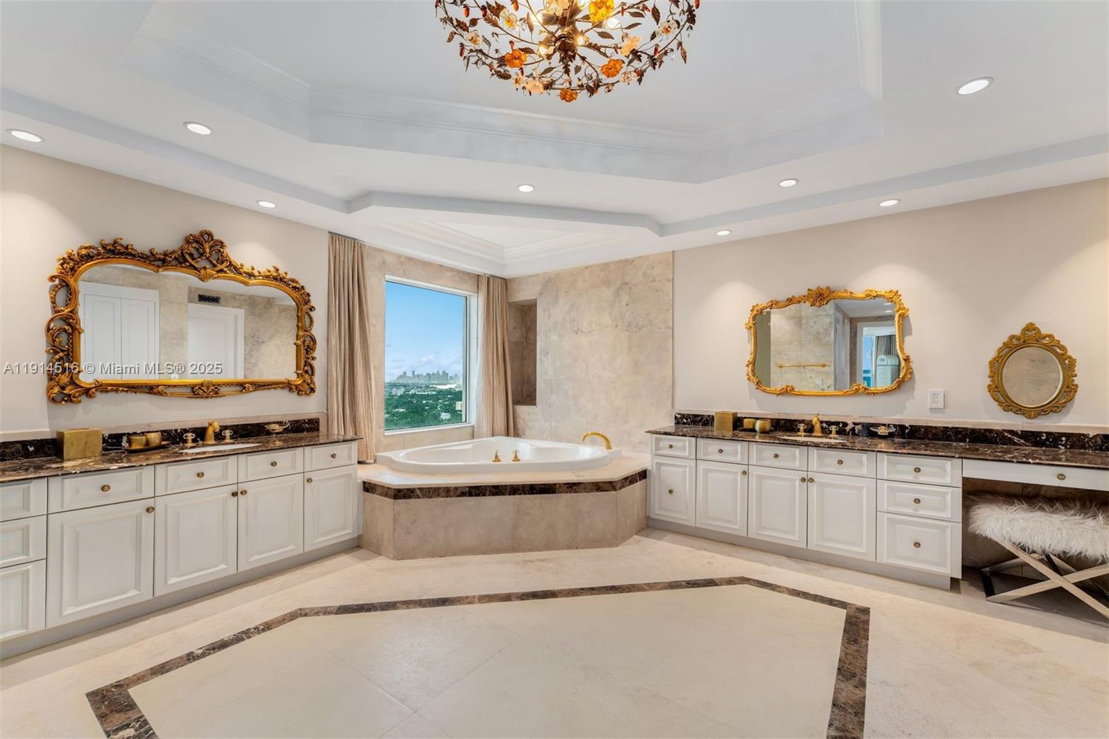 5025 Collins Avenue, Unit PH1 Miami Beach, FL 33140 - Photo 32 of 62 a large bathroom with a granite countertop sink a large mirror and a bathtub next to a window