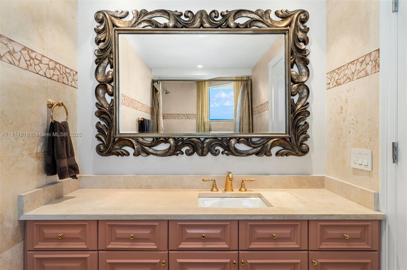 5025 Collins Avenue, Unit PH1 Miami Beach, FL 33140 - Photo 37 of 62 a bathroom with a sink and a mirror