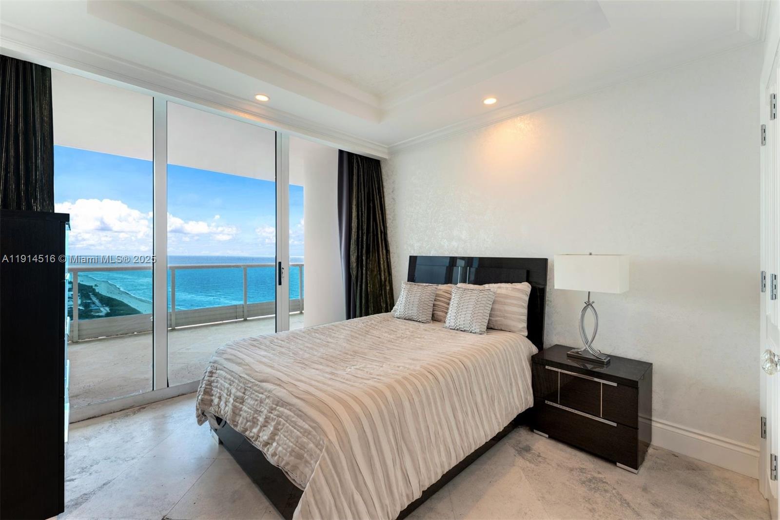 5025 Collins Avenue, Unit PH1 Miami Beach, FL 33140 - Photo 39 of 62 a bedroom with a bed and large mirror