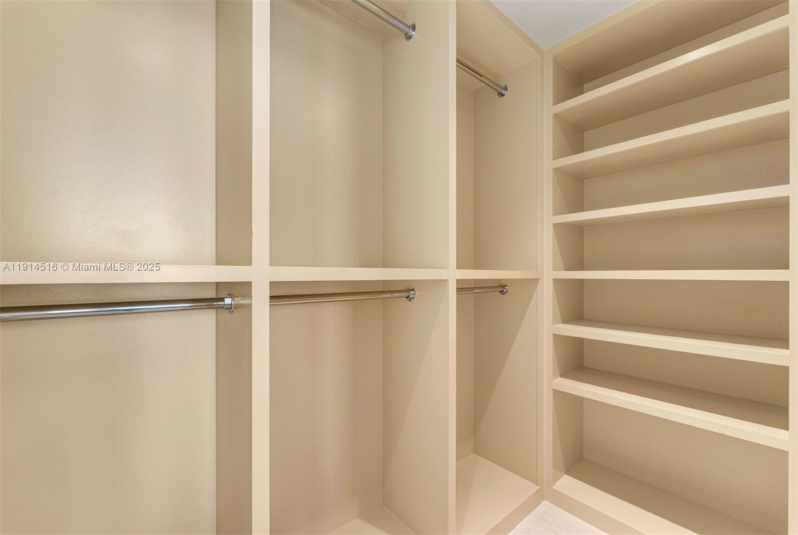 5025 Collins Avenue, Unit PH1 Miami Beach, FL 33140 - Photo 41 of 62 a view of walk in closet with empty racks