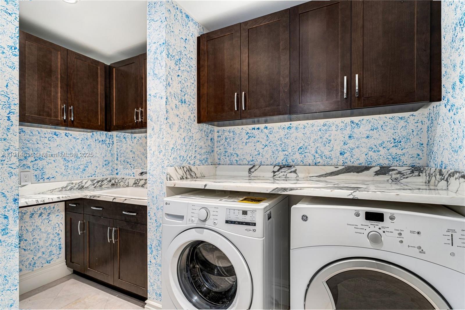 5025 Collins Avenue, Unit PH1 Miami Beach, FL 33140 - Photo 44 of 62 a view of a kitchen with sink washer and dryer