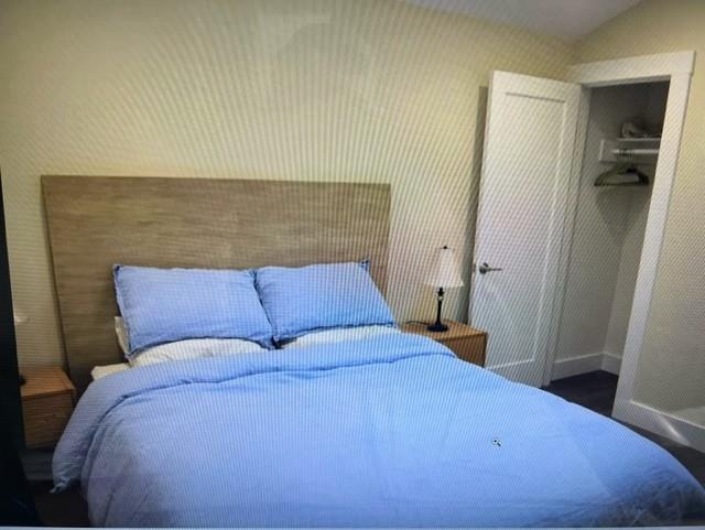 333 Brighton Road Pacifica, CA 94044 - Photo 5 of 14 a bed sitting in a bedroom next to a bathroom