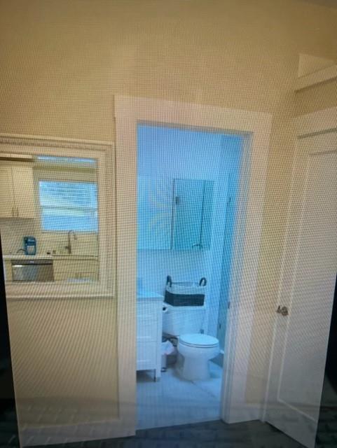 333 Brighton Road Pacifica, CA 94044 - Photo 8 of 14 a bathroom with a sink a toilet and a mirror