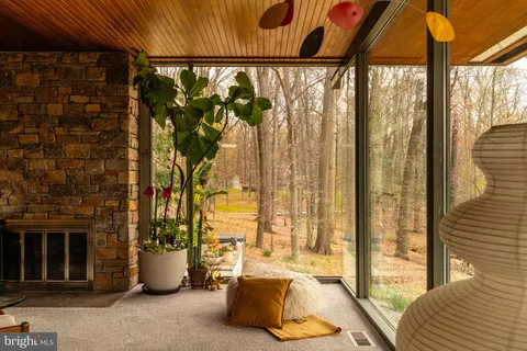 a living room with furniture and floor to ceiling windows
