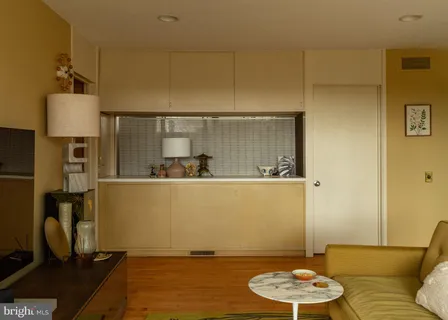 a living room with furniture and a floor to ceiling window