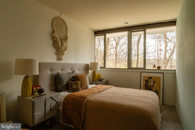 a bedroom with a large bed and a window