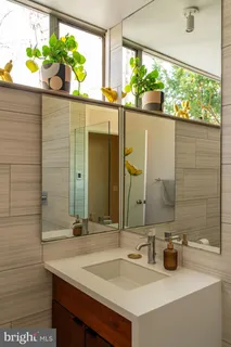 a bedroom with a bed couch and a large window