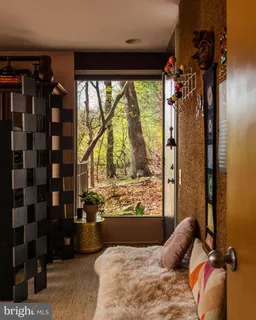 a bedroom with a bed and large windows with outer view