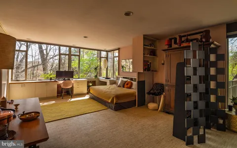 a living room with lots of furniture and a large window