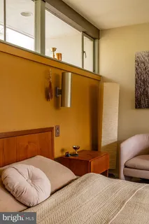 front view of house with a large window and potted plants