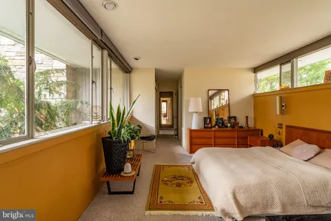 a view of a house with swimming pool and sitting area