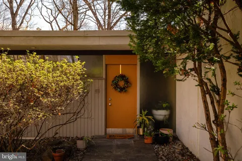 a living room with furniture and floor to ceiling window