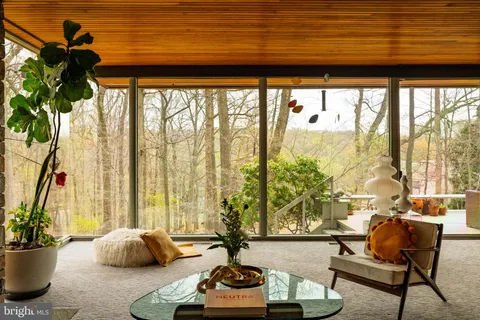 a living room with patio furniture and a fireplace