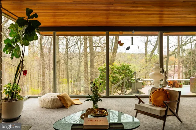 a living room with patio furniture and a fireplace