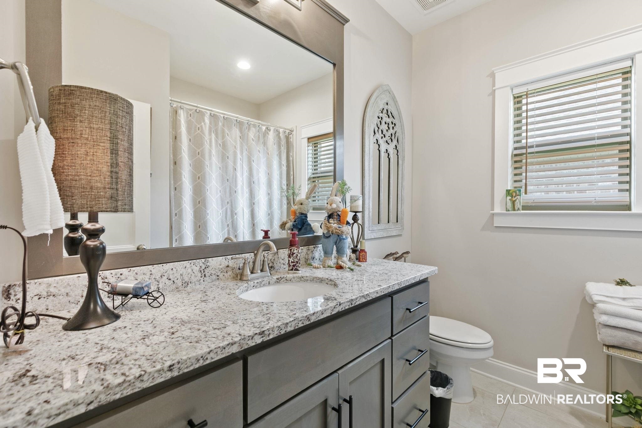 291 Hemlock Drive Fairhope, AL 36532 - Photo 39 of 65 Bathroom featuring curtained shower, vanity, and light tile patterned flooring
