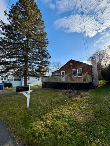 a view of a street with a yard