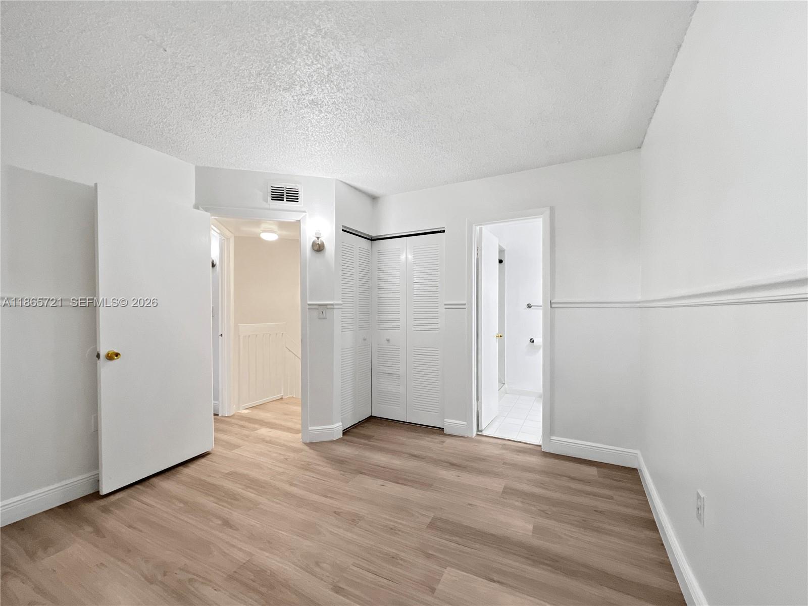 8515 Northwest 3rd Lane, Unit 1109 Miami, FL 33126 - Photo 12 of 14 a view of empty room with wooden floor and windows