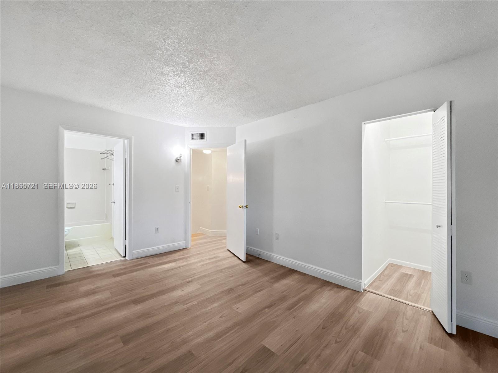 8515 Northwest 3rd Lane, Unit 1109 Miami, FL 33126 - Photo 10 of 14 an empty room with wooden floor and closet