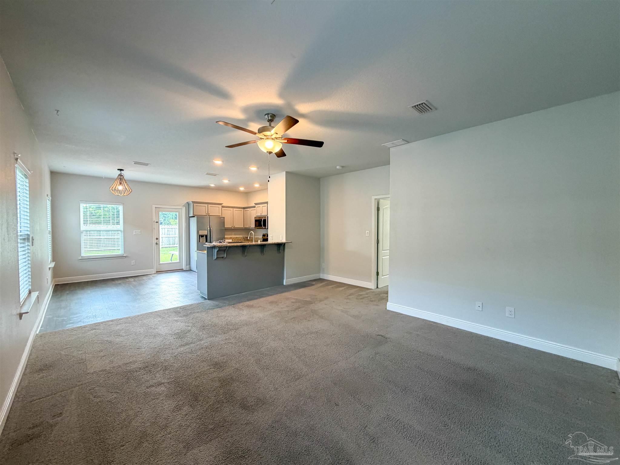 3613 Conley Drive Cantonment, FL 32533 - Photo 2 of 32 an empty room with a kitchen and a fireplace