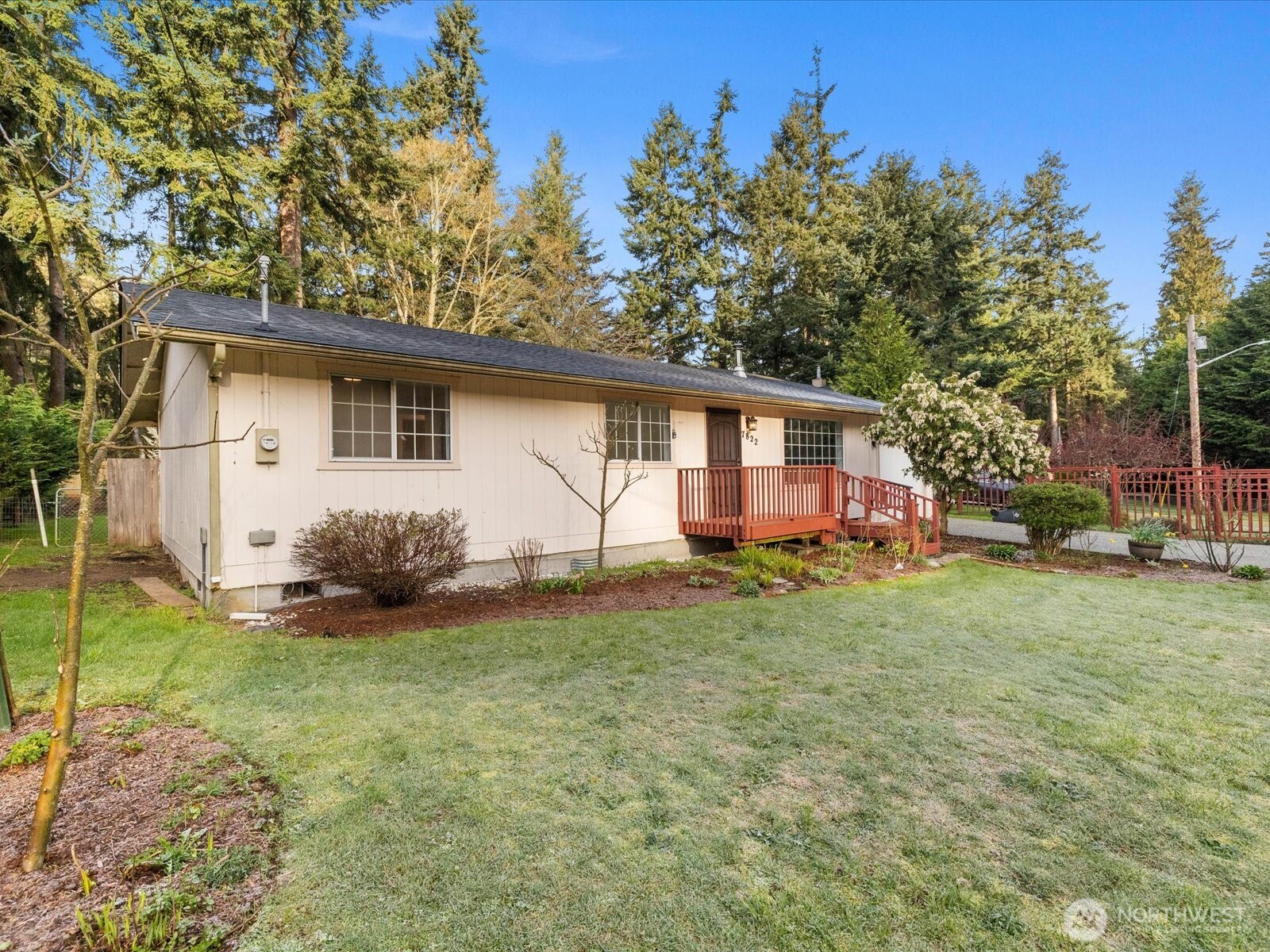 7822 Songbird Way Clinton, WA 98236 - Photo 1 of 28 a view of a house with backyard and trees