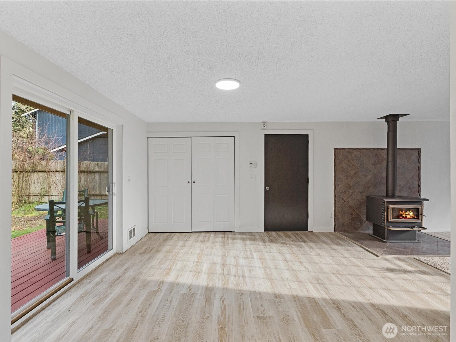 7822 Songbird Way Clinton, WA 98236 - Photo 13 of 28 a view of a livingroom with wooden floor and furniture
