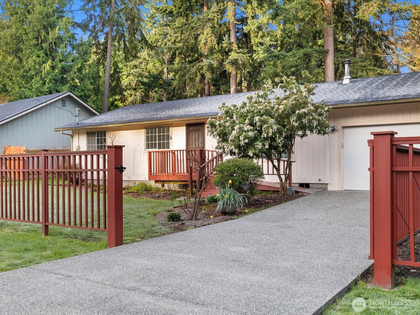 7822 Songbird Way Clinton, WA 98236 - Photo 2 of 28 a view of a house with a yard and fence