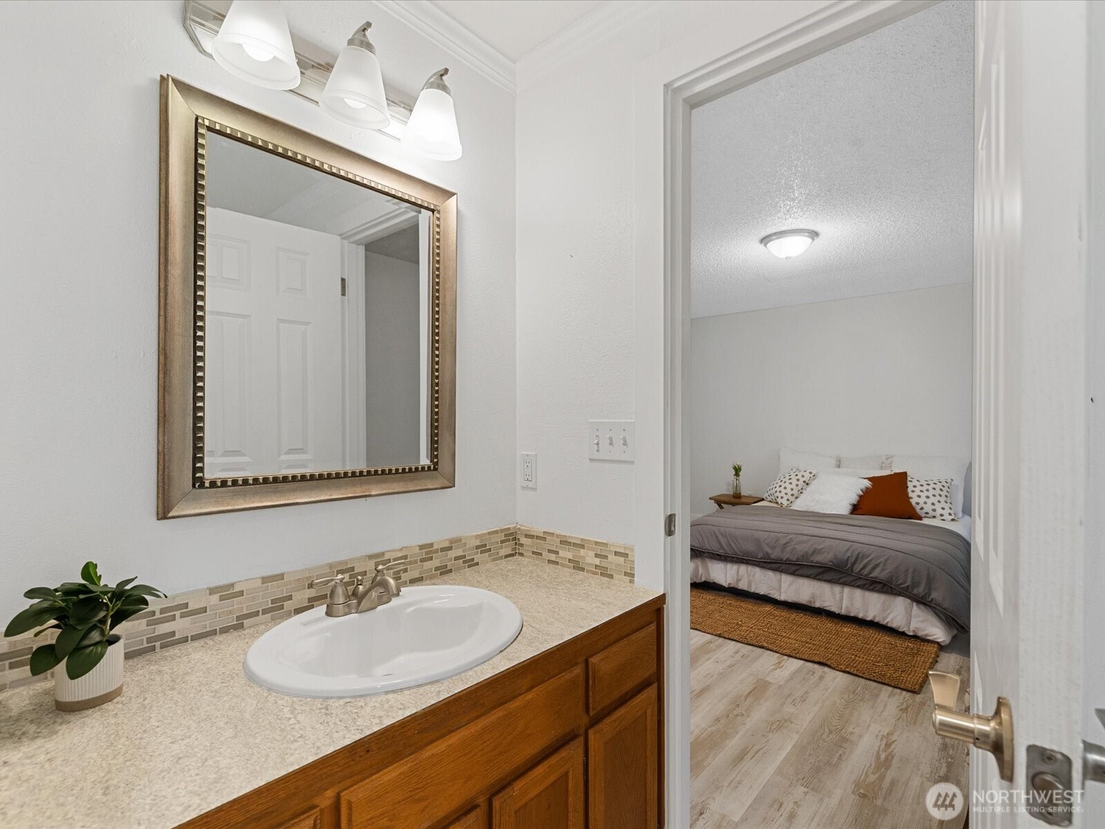 7822 Songbird Way Clinton, WA 98236 - Photo 21 of 28 a en suite bathroom with a granite countertop sink and a mirror