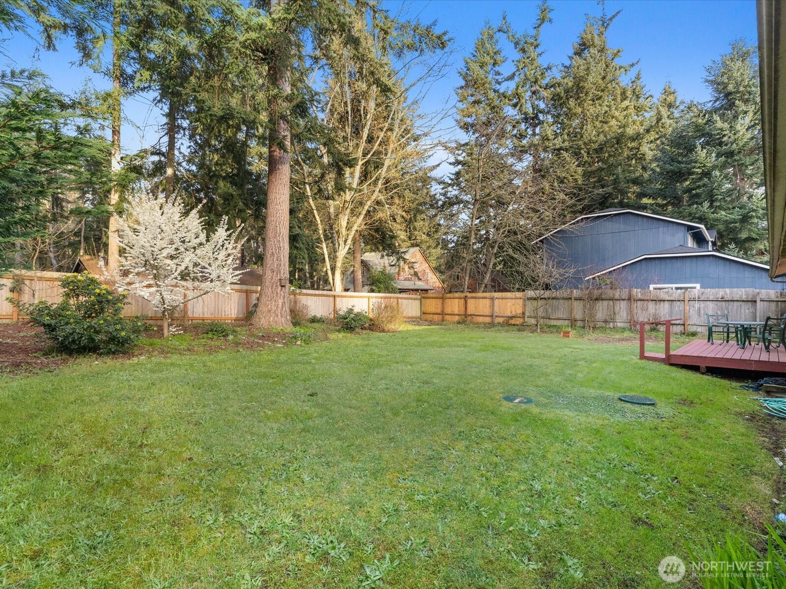7822 Songbird Way Clinton, WA 98236 - Photo 23 of 28 a view of a house with a backyard