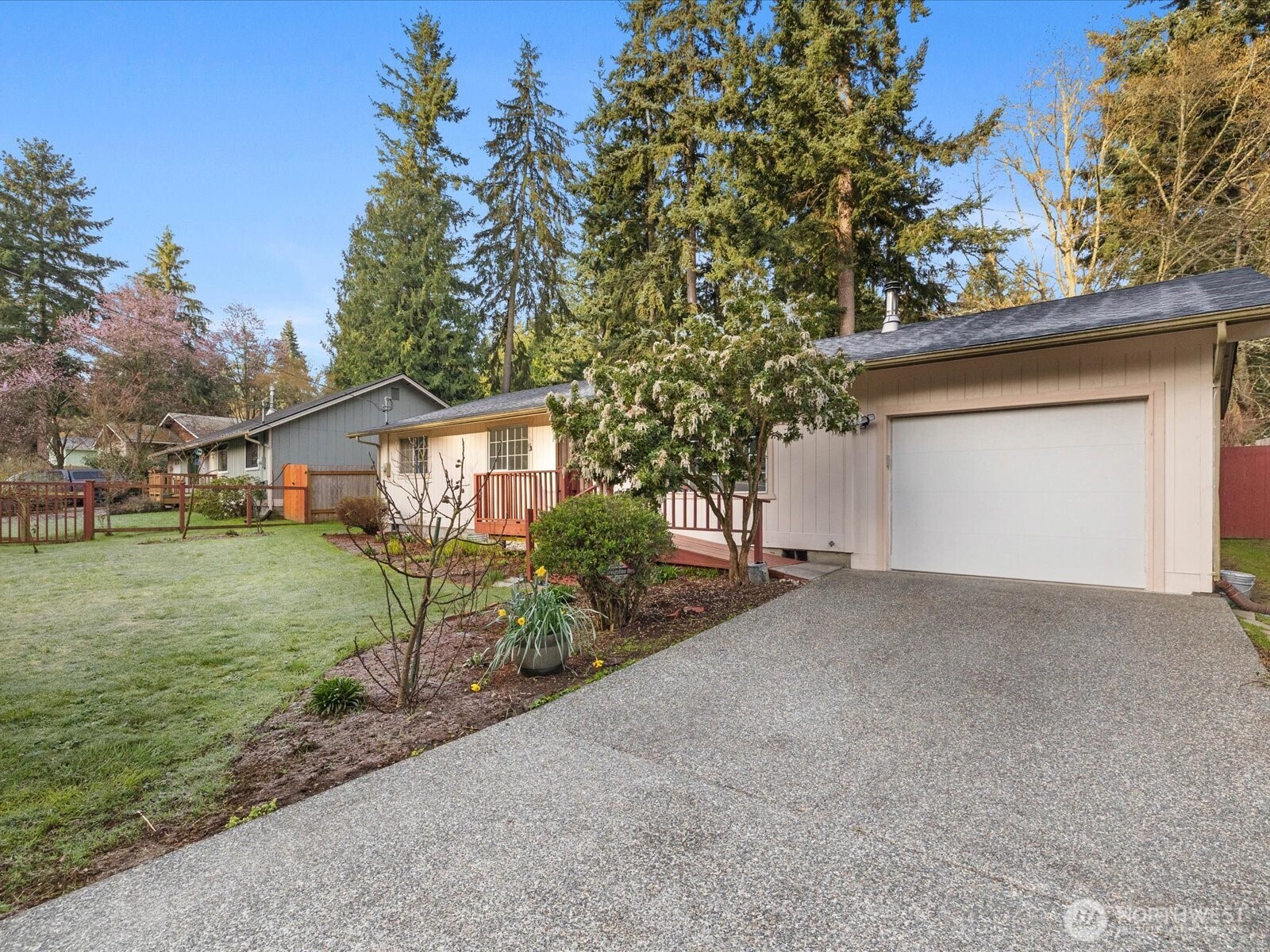 7822 Songbird Way Clinton, WA 98236 - Photo 3 of 28 a view of a house with a yard and garage