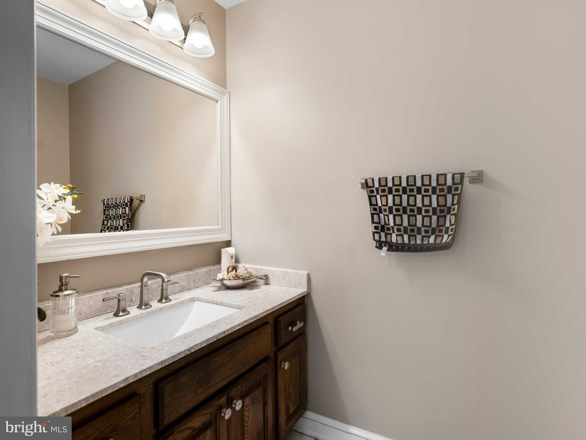 5 Radburn Lane Landenberg, PA 19350 - Photo 30 of 67 a bathroom with a granite countertop sink a mirror and vanity