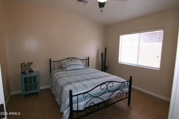 a bedroom with a bed and window