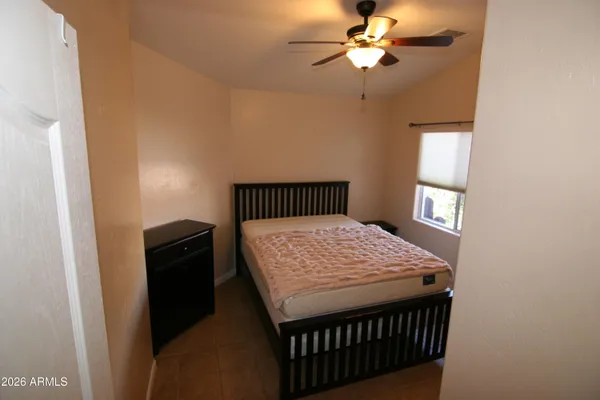 a bedroom with a bed and a chandelier
