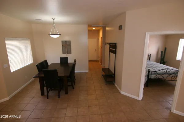 a view of a dining room with furniture and a chandelier