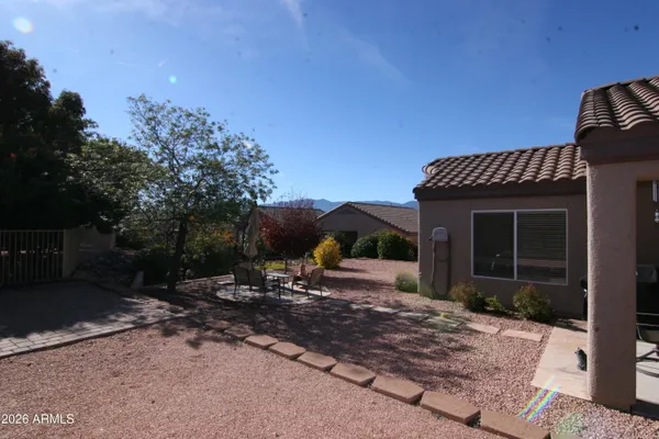 a view of a house with backyard and sitting area