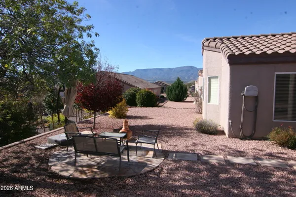 a view of a backyard with sitting area