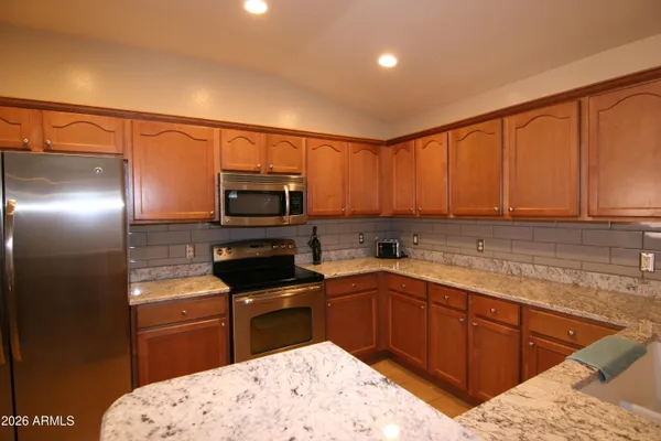 a kitchen with a sink a microwave and cabinets