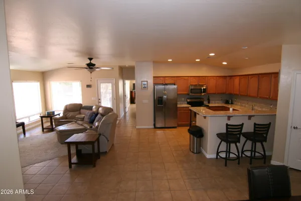 a living room with furniture and kitchen view