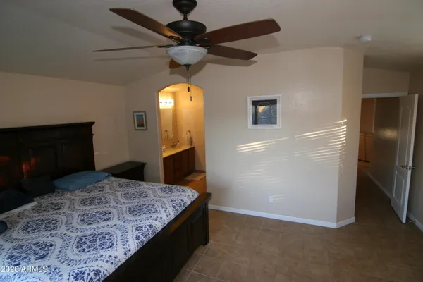 a bedroom with a bed and a television in it