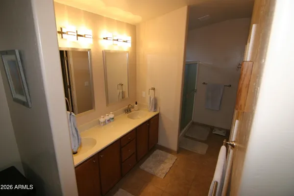 a bathroom with a double vanity sink and mirror