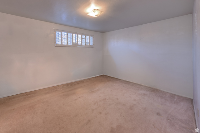 738 Locust Lane Moab, UT 84532 - Photo 17 of 25 Unfurnished room with light carpet and baseboards